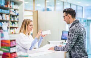 female pharmacist serving a male customer .jpg