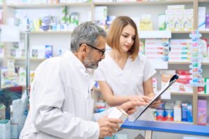 two pharmacist checking product in folder.jpg