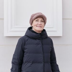 winter portrait of smiling senior woman looking at camera wearing faux pink fur cap .jpg